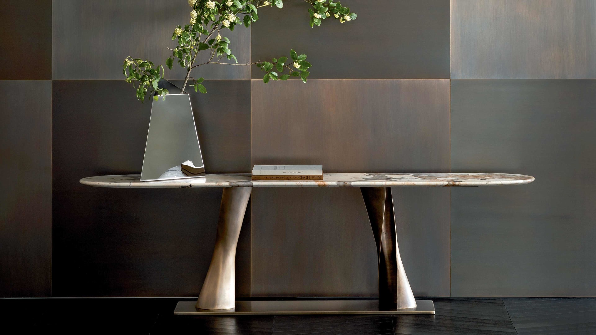 Rea console | Rugiano. Sculptural console featuring a unique bronze fusion base and an elegant oblong oval top in various luxurious finishes.