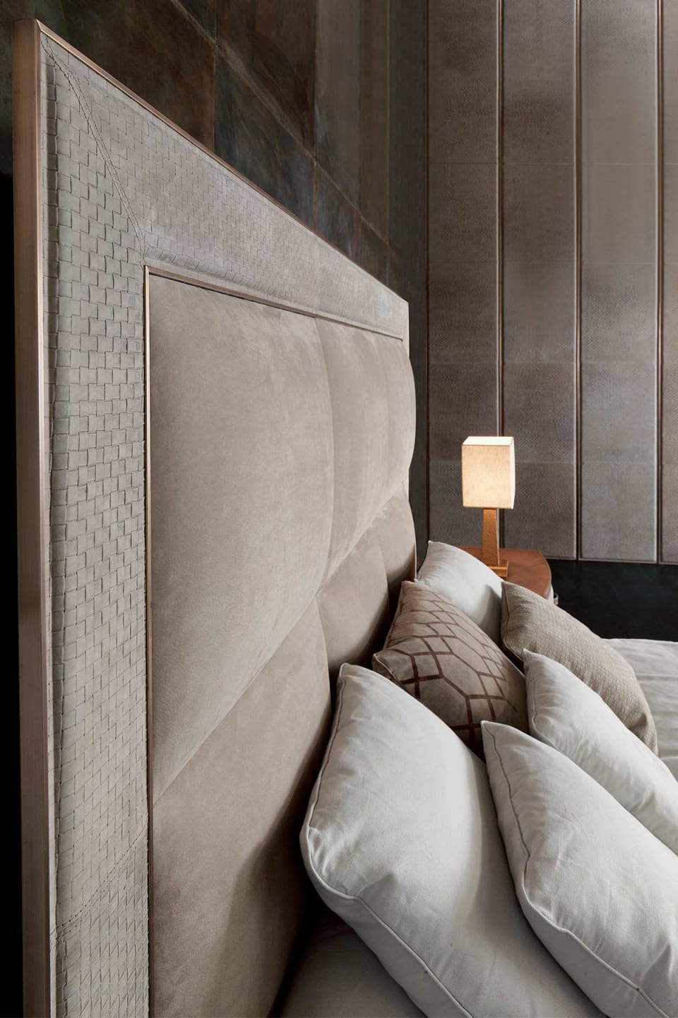 Aura bed | Rugiano. Luxurious bed with geometrically padded upholstered headboard and elegant metal details, designed for ultimate comfort.