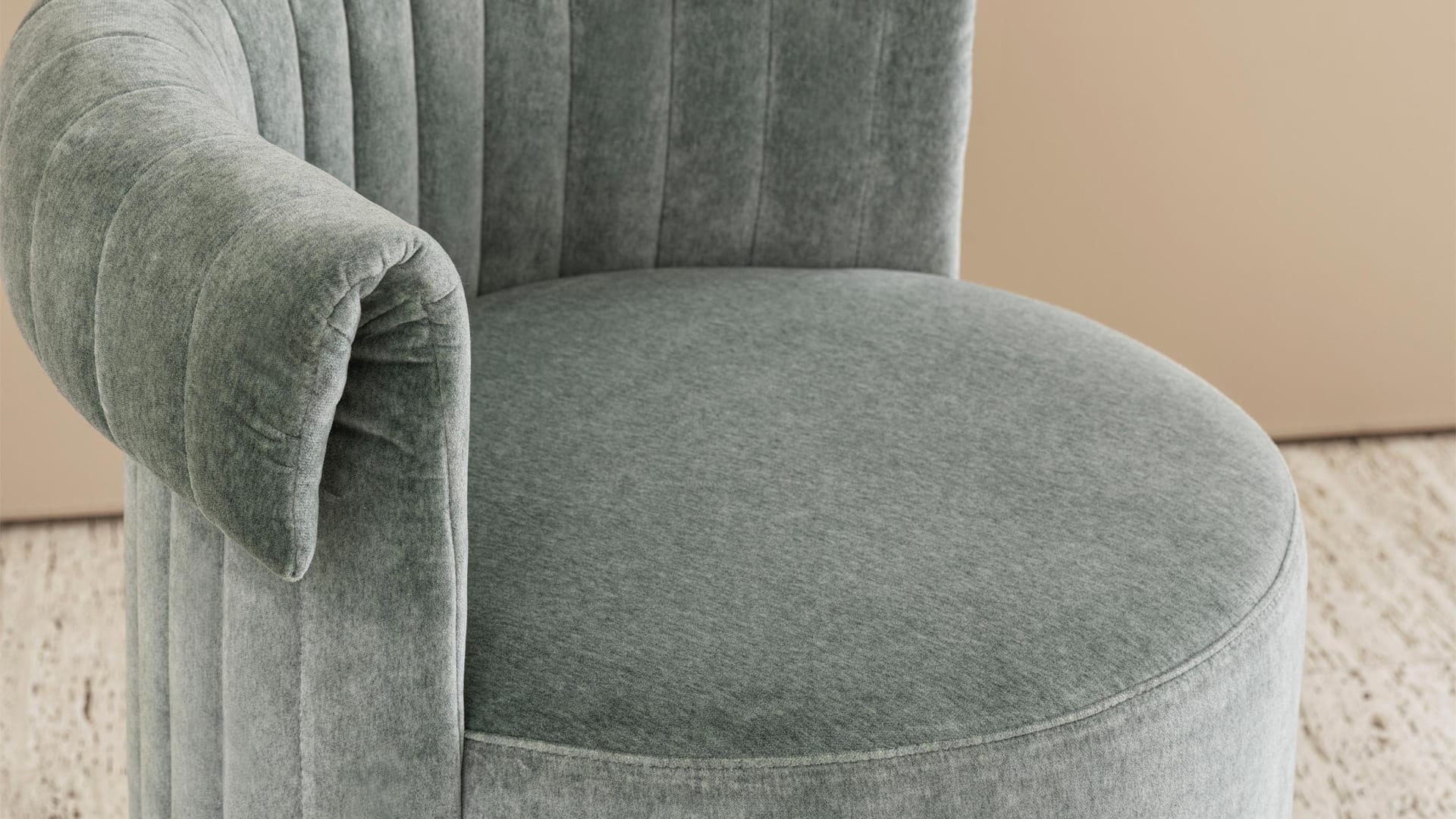 Manta pouf | Rugiano. Luxury velvet pouf with a unique curved armrest and golden base, a perfect accent for elegant interiors.