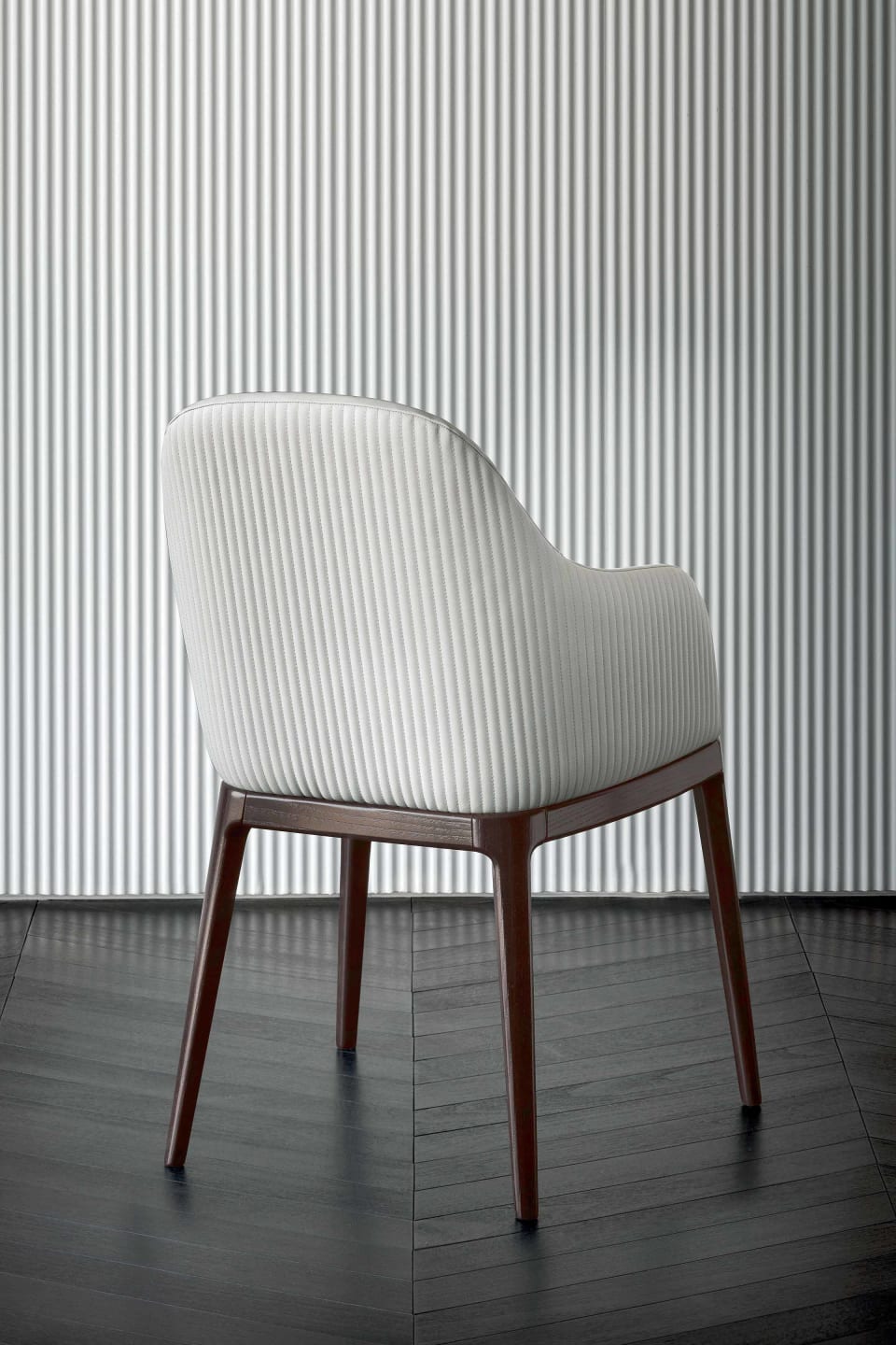 Pocket P chair | Rugiano. Upholstered chair with wooden legs, offering comfort and modern design with an option for a high back.