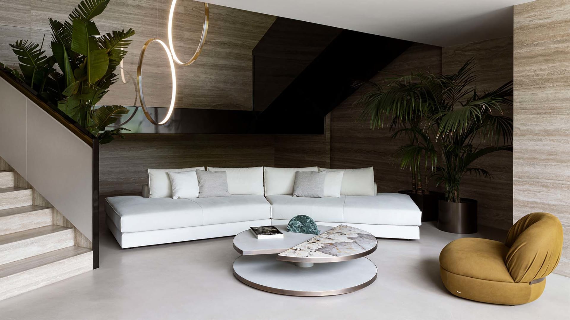 Nautilus sofa | Rugiano. Modular sofa system with integrated bookshelves, shelves, and side tables, featuring distinctive raw-cut leather details.