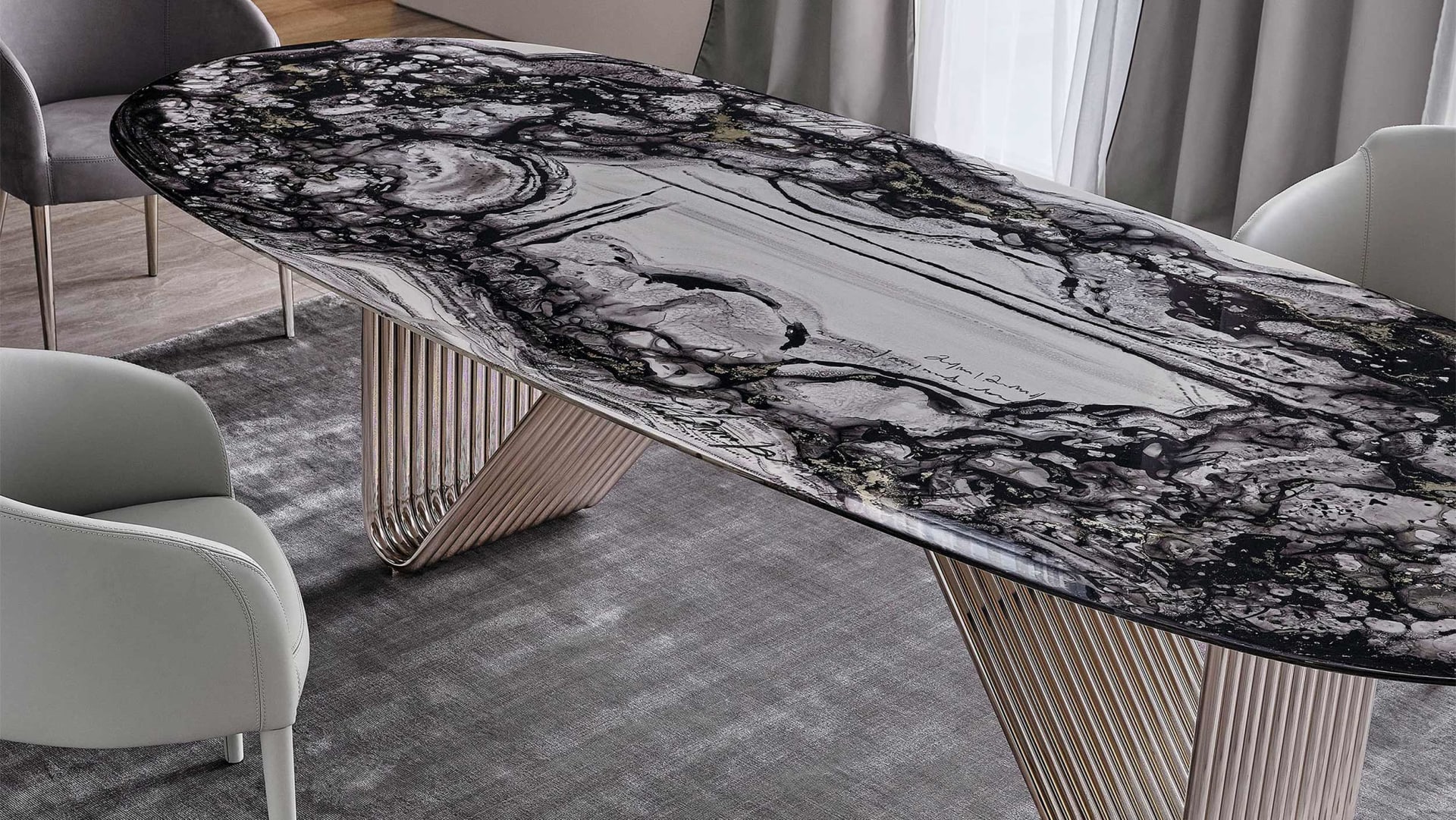 Alyson table | Rugiano. Elegant dining table with curved metal base and versatile top options in wood, marble, glass, or leather.