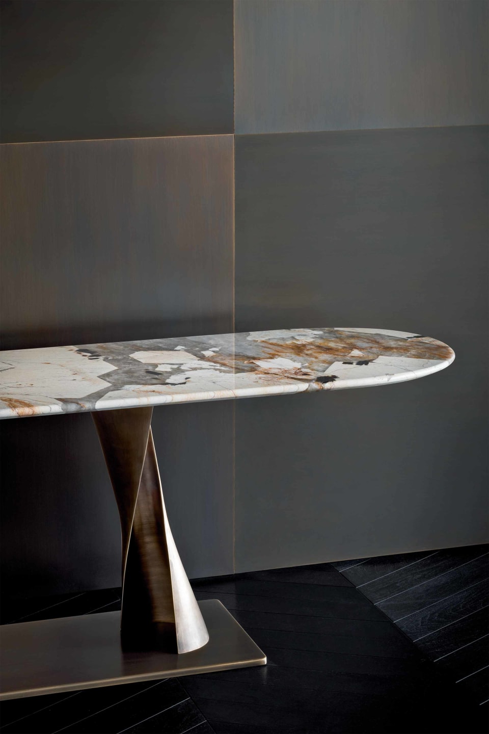 Rea console | Rugiano. Sculptural console featuring a unique bronze fusion base and an elegant oblong oval top in various luxurious finishes.