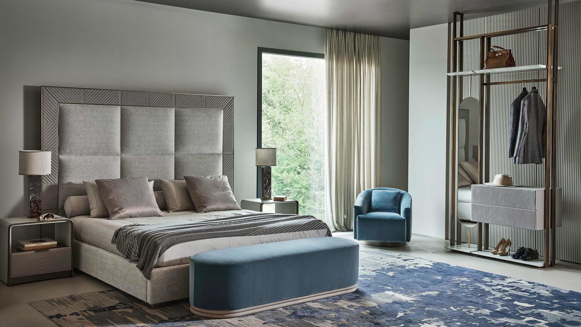 Aura bed | Rugiano. Luxurious bed with geometrically padded upholstered headboard and elegant metal details, designed for ultimate comfort.