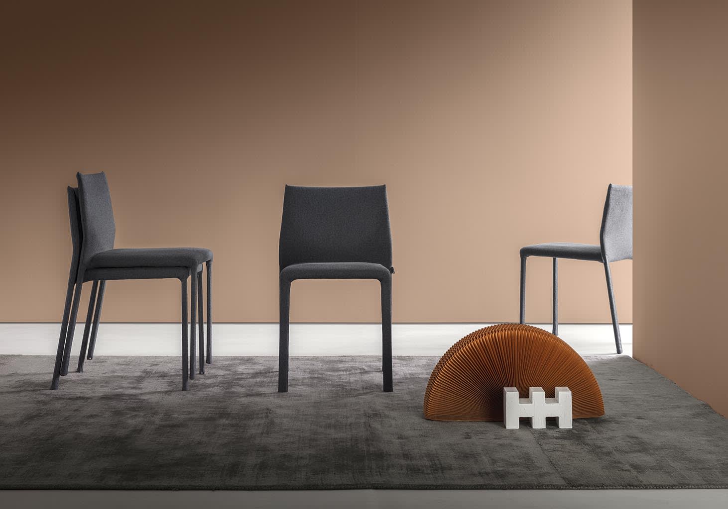 Corium chair | ALF Dafre. Compact designer chair with leather, fabric upholstery options and two backrest heights.
