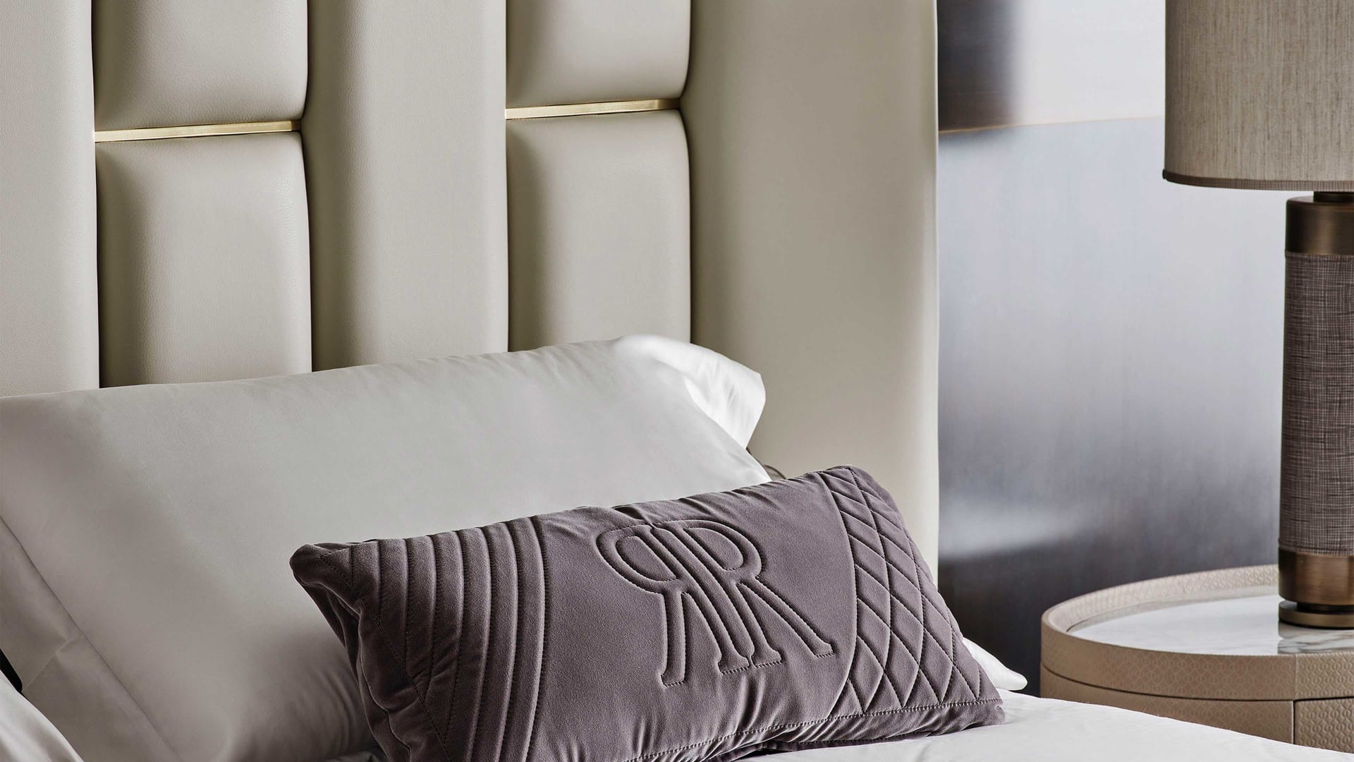 Victoria bed | Rugiano. Luxurious upholstered bed with a distinctive geometric headboard and elegant metal details.