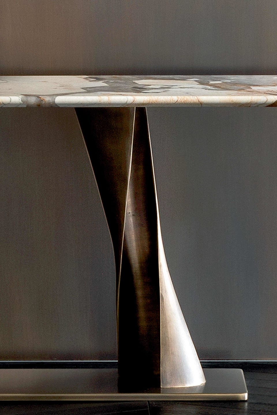 Rea console | Rugiano. Sculptural console featuring a unique bronze fusion base and an elegant oblong oval top in various luxurious finishes.
