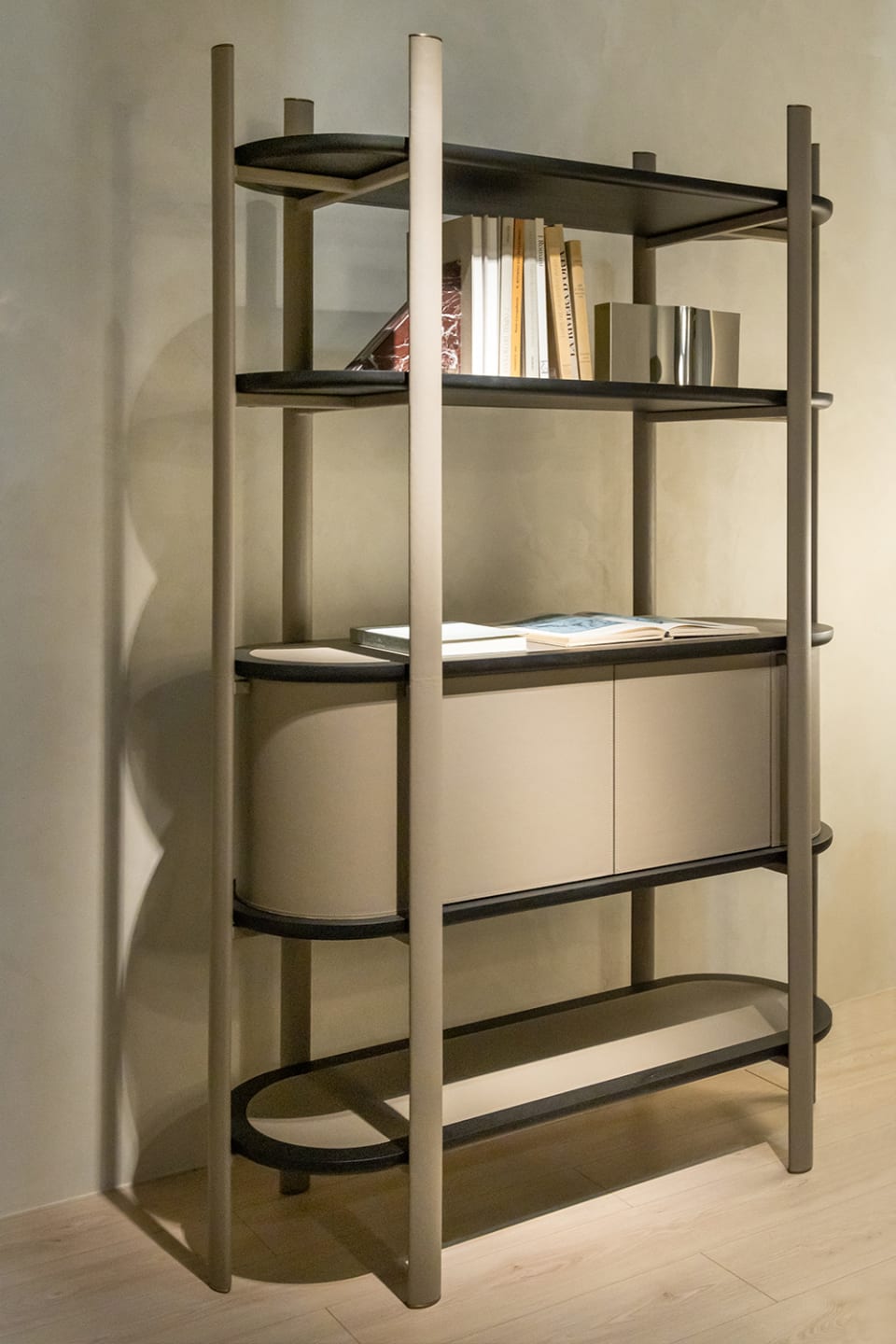 Coquette bookcase | Rugiano. Elegant Art Deco and Modern style bookcase with rounded forms, combining open shelves and closed compartments.