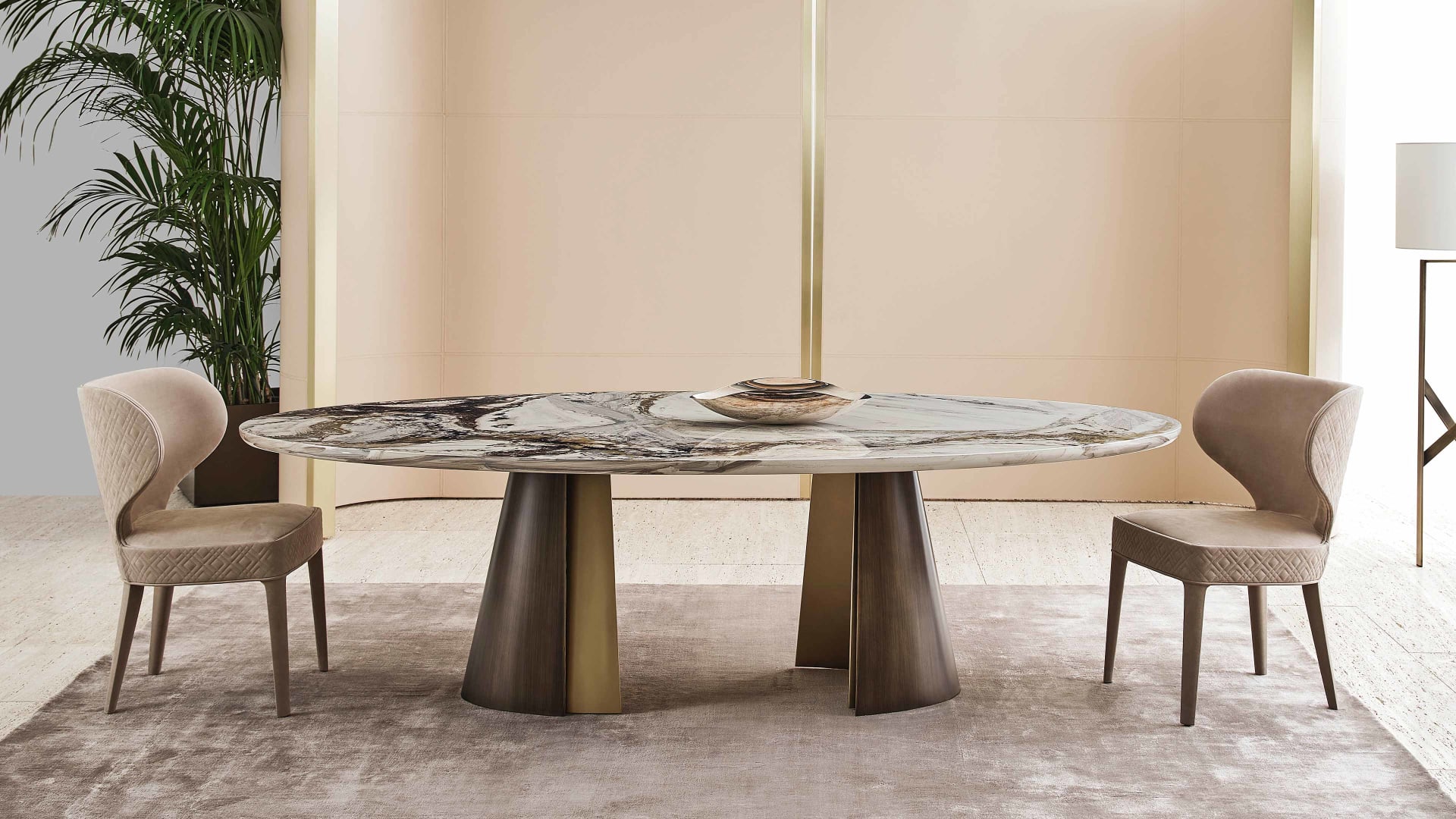 Absolute table | Rugiano. A luxurious dining table featuring a sculptural metal base with contrasting finishes and versatile top options.
