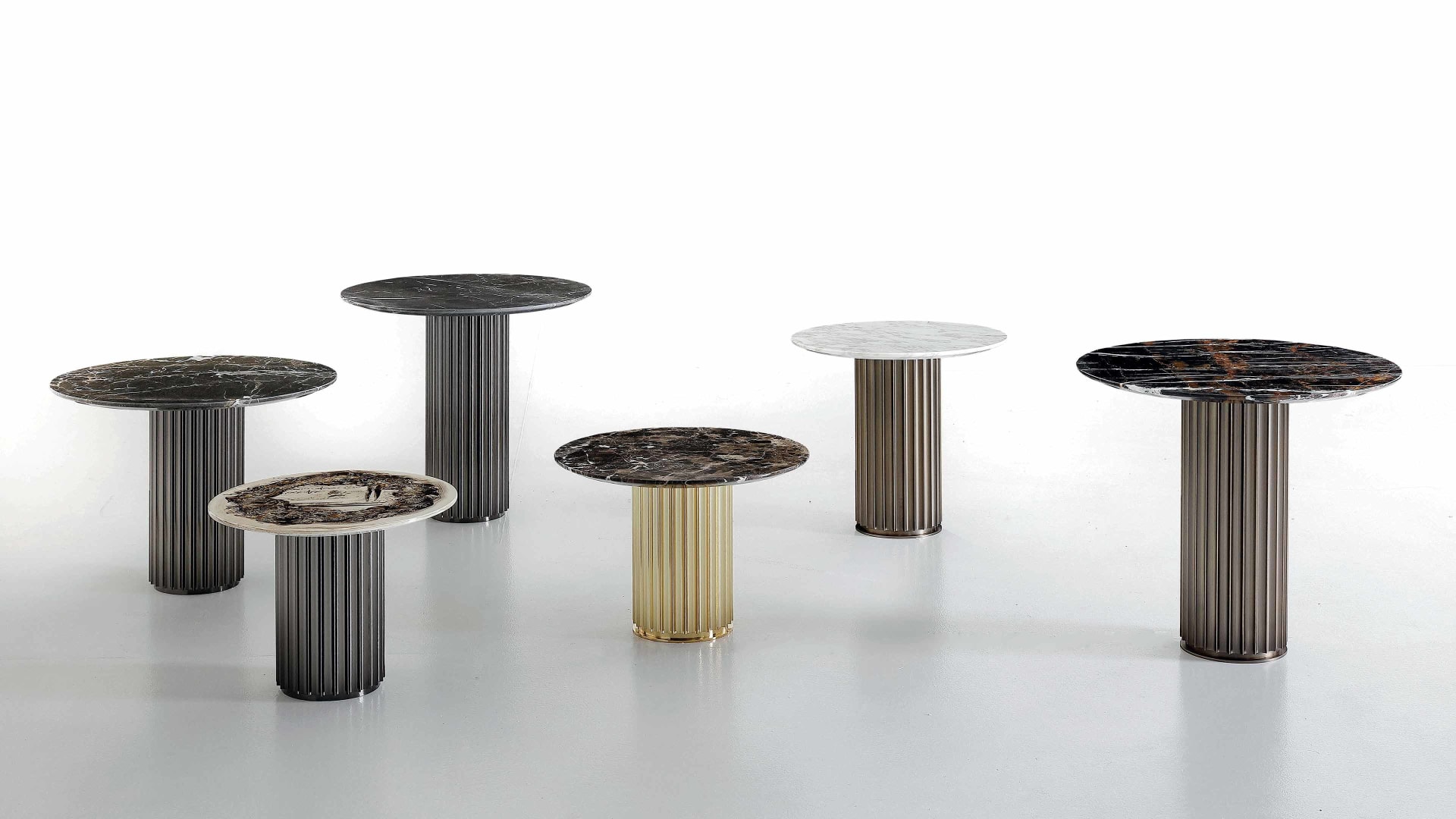 Liberty coffee table | Rugiano. Elegant coffee table with a distinctive column-like bronze-finished base and versatile round tops.
